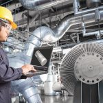 Engineer_using_laptop_computer_in_thermal_power_plant_factory