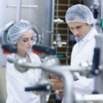 Biologist_team_talking_and_wearing_hairnet_in_the_factory