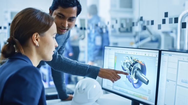 Modern_Factory_Office:_Portrait_of_Male_Project_Supervisor_Talking_with_a_Female_Industrial_Engineer,_They_Point_at_Computer_Display_Showing_CAD_Software_with_3D_Engine_Concept._Team_Problem_Solving