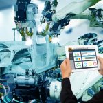 iot_industry_4.0_concept,industrial_engineer_using_software_(augmented,_virtual_reality)_in_tablet_to_monitoring_machine_in_real_time.Smart_factory_use_Automation_robot_arm_in_automotive_manufacturing